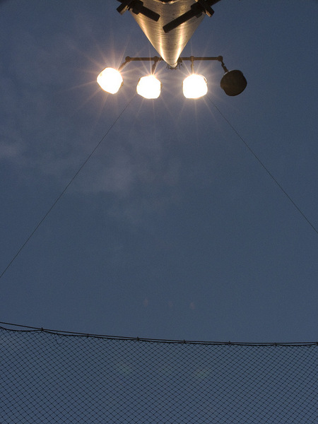 Baseball field light pole at twilight.