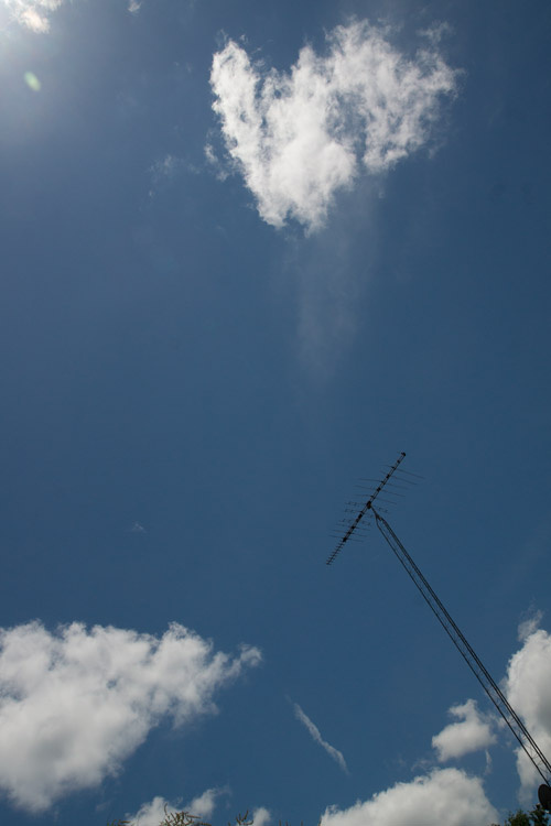 June 17   The storms, and their beauty, passed, giving way to the beauty of blue skies and clouds. Even the stark lines of the ham radio antenna seem beautiful with the sky.