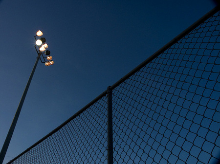 Baseball field light poles at twilight.