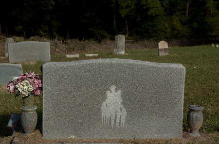 November 3  The man's name was on the other side of the gravestone, but his image of a man with cowboy hat, cowboy boots and five children told me everything I needed to know. I already like this stranger and wished we could have met.