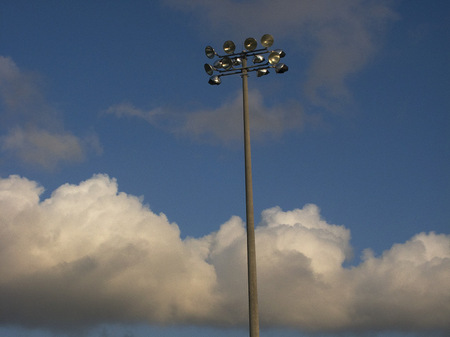 Light pole on wave of clouds.