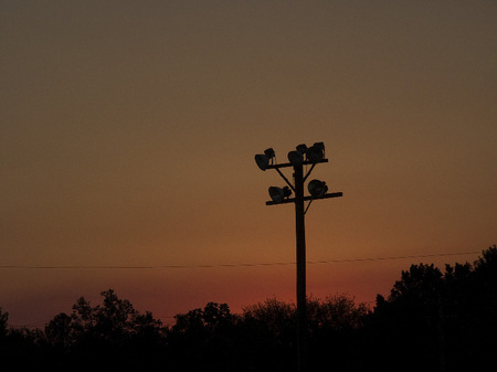 Athletic field light pole at dusk.