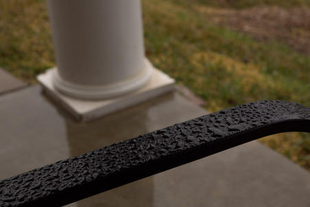 February 19   Rain drops on the arm of the chair on the porch beckon me to warmer days. For now, the shapes, textures and colors give me pause to appreciate before heading back in to warmer temperatures.